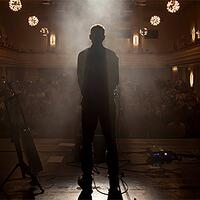tex, silhouettenportrait auf bühne vor publikum