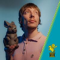 robert alan, portrait mit tierfigur vor blauem hintergrund